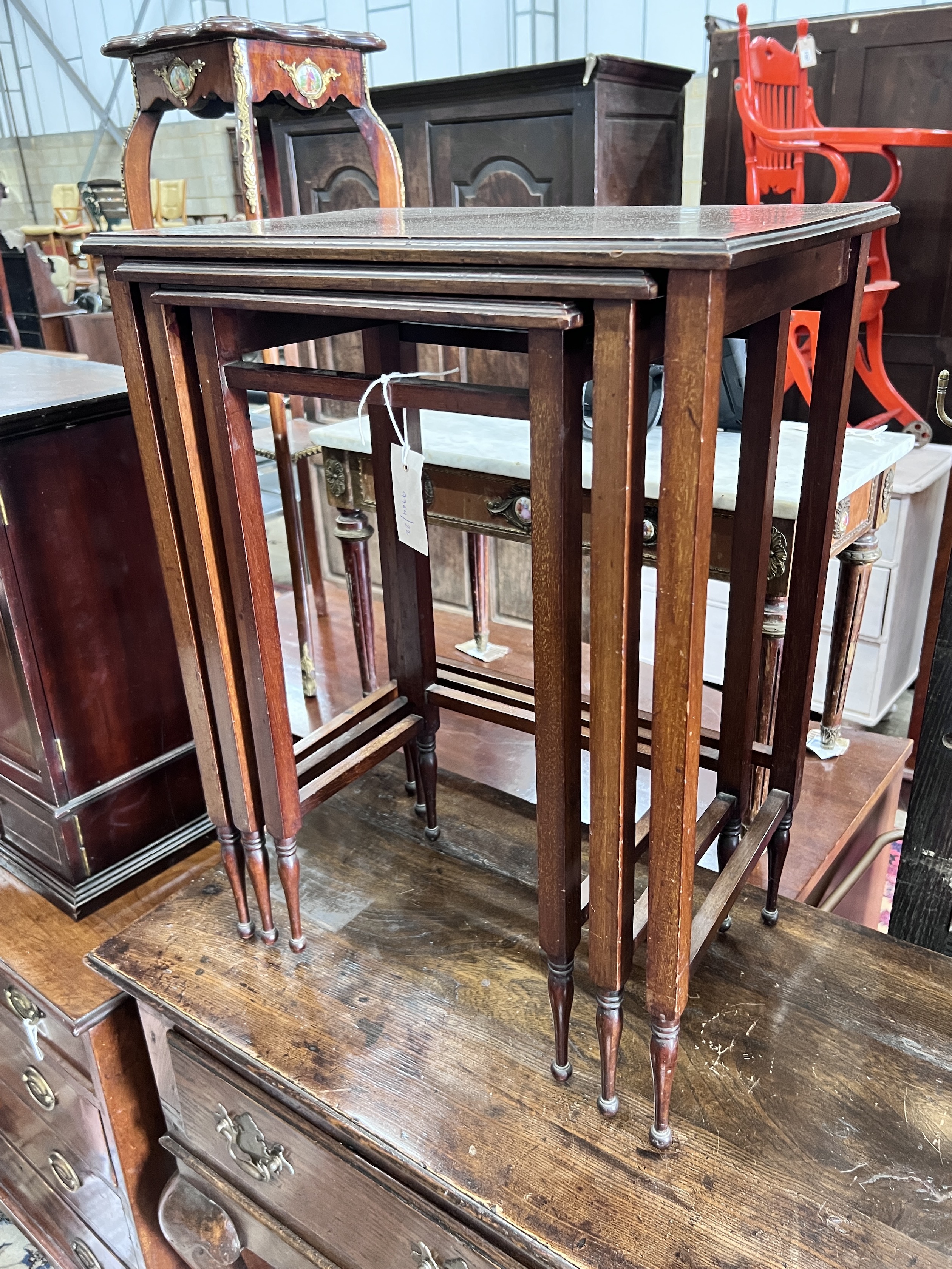 A nest of three Edwardian satinwood banded rectangular mahogany tea tables, width 48cm, depth 32cm, height 64cm